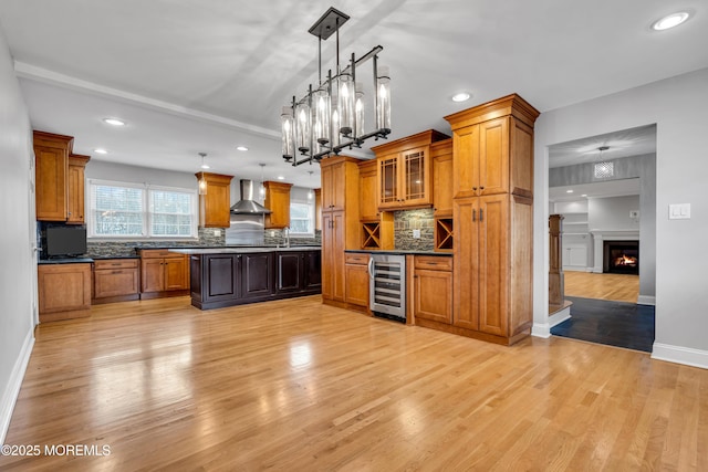 6 Kenneth Dr, Ocean Twp, NJ 07712 - kitchen featuring wall chimney exhaust hood, beverage cooler, light wood finished floors, brown cabinetry, and recessed lighting