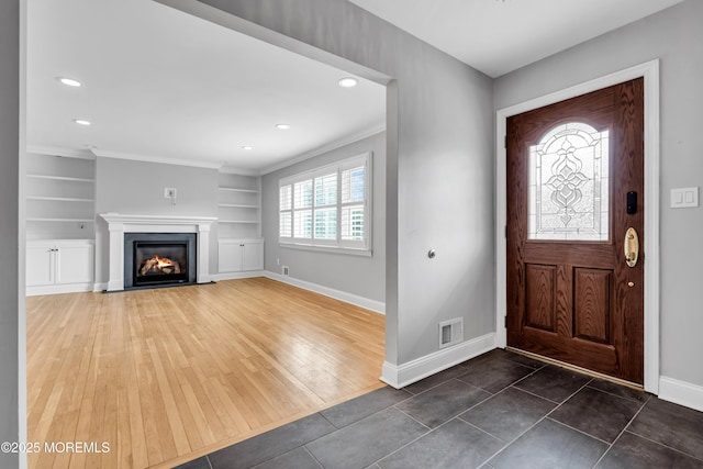 6 Kenneth Dr, Ocean Twp, NJ 07712 - foyer entrance with baseboards, recessed lighting, a fireplace with flush hearth, crown molding, and dark wood-style flooring