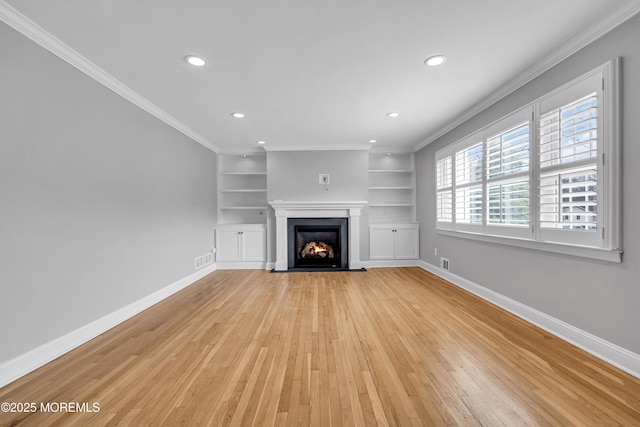 6 Kenneth Dr, Ocean Twp, NJ 07712 - unfurnished living room featuring light wood finished floors, baseboards, crown molding, recessed lighting, and built in shelves