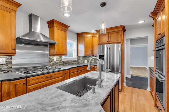 6 Kenneth Dr, Ocean Twp, NJ 07712 - kitchen with wall chimney exhaust hood, a sink, stainless steel appliances, brown cabinetry, and decorative light fixtures
