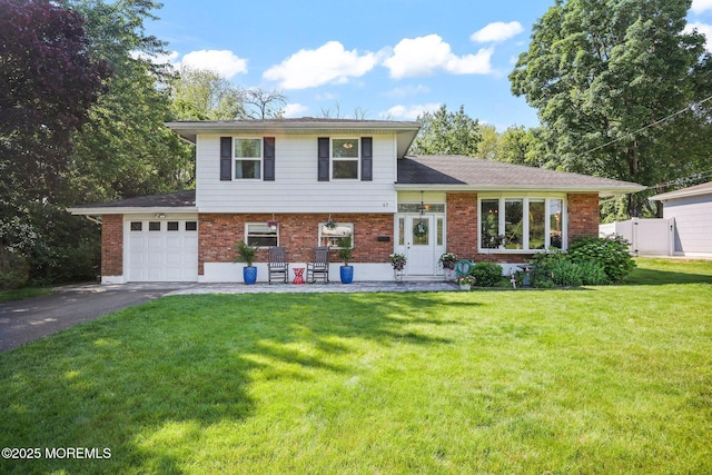 67 Koenig Ln, Freehold, NJ 07728 - split level home featuring asphalt driveway, brick siding, and a garage
