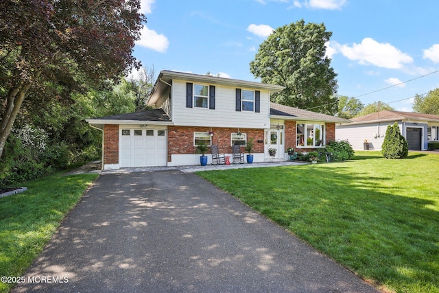 67 Koenig Ln, Freehold, NJ 07728 - tri-level home with brick siding, driveway, an attached garage, and a front yard
