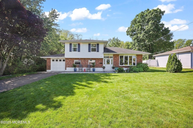 67 Koenig Ln, Freehold, NJ 07728 - tri-level home with brick siding, an attached garage, and asphalt driveway