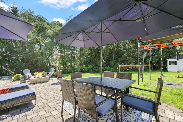 67 Koenig Ln, Freehold, NJ 07728 - view of patio with a fire pit, outdoor dining space, and an outbuilding