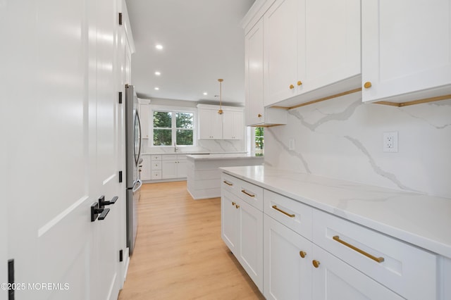 783 Delaware Ave, Manahawkin, NJ 08050 - kitchen with tasteful backsplash, white cabinetry, freestanding refrigerator, light wood-style flooring, and recessed lighting