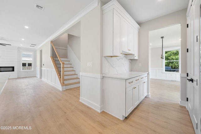 783 Delaware Ave, Manahawkin, NJ 08050 - hall with stairway, light wood-style flooring, recessed lighting, a decorative wall, and a wainscoted wall