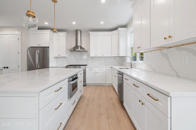 783 Delaware Ave, Manahawkin, NJ 08050 - kitchen featuring appliances with stainless steel finishes, wall chimney range hood, a sink, recessed lighting, and white cabinets