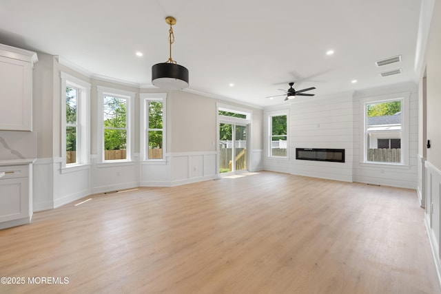 783 Delaware Ave, Manahawkin, NJ 08050 - unfurnished living room with a ceiling fan, healthy amount of natural light, crown molding, a fireplace, and recessed lighting