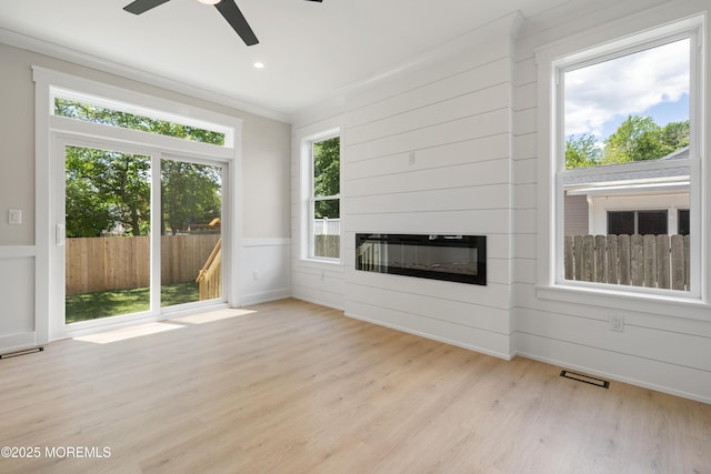 783 Delaware Ave, Manahawkin, NJ 08050 - unfurnished living room featuring light wood finished floors, ceiling fan, crown molding, and a glass covered fireplace