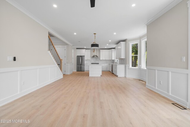 783 Delaware Ave, Manahawkin, NJ 08050 - unfurnished living room with ornamental molding, recessed lighting, a decorative wall, light wood-style flooring, and stairs