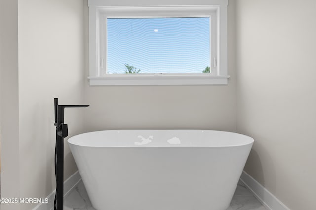 783 Delaware Ave, Manahawkin, NJ 08050 - full bath featuring marble look tiles, a soaking tub, baseboards, and plenty of natural light