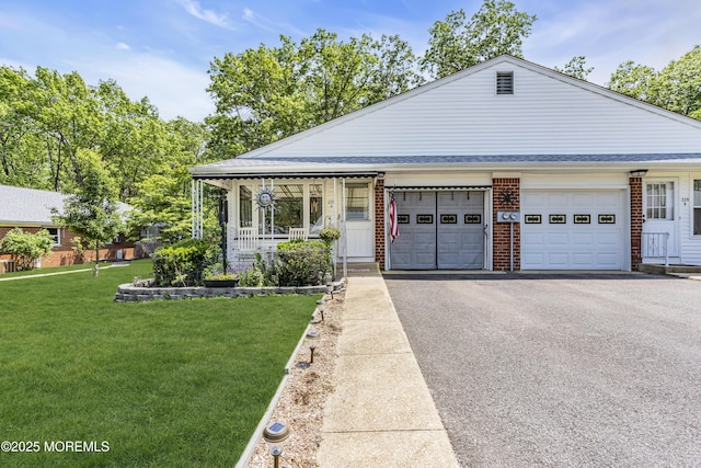 235 Columbine Ave Unit A, Whiting, NJ 08759 - view of front of home featuring asphalt driveway, a front yard, a garage, brick siding, and covered porch