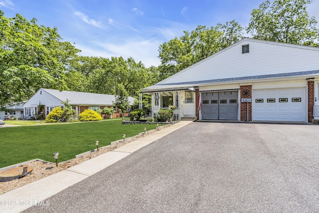 235 Columbine Ave Unit A, Whiting, NJ 08759 - view of front of house with driveway, brick siding, a front yard, and an attached garage