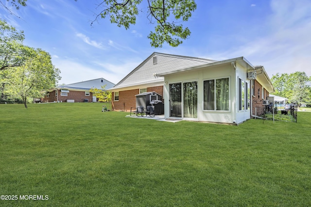 235 Columbine Ave Unit A, Whiting, NJ 08759 - rear view of property featuring a yard, brick siding, and a patio