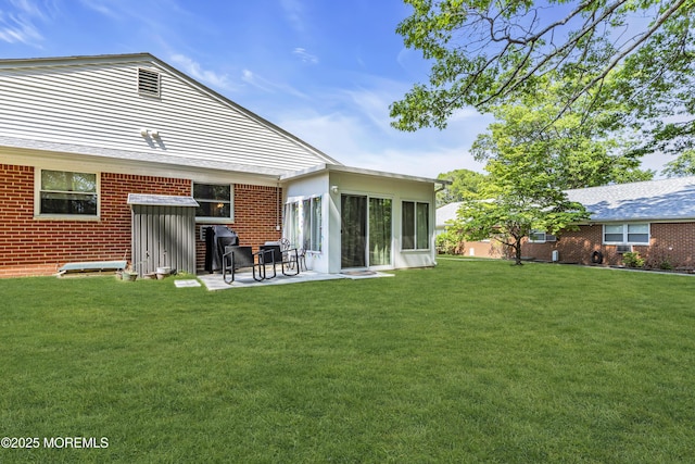 235 Columbine Ave Unit A, Whiting, NJ 08759 - rear view of property with a lawn, a sunroom, a patio area, and brick siding