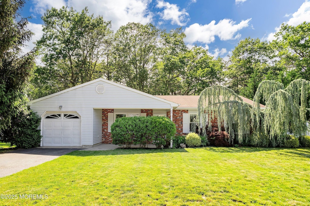 38 Cherry Ln, Howell, NJ 07731 - view of front of house featuring brick siding, an attached garage, a front yard, and asphalt driveway