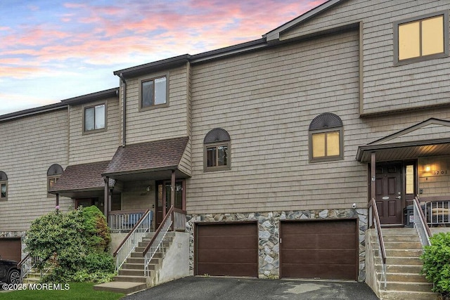 1202 Alpine Trl, Neptune Township, NJ 07753 - multi unit property with asphalt driveway, an attached garage, stairway, and stone siding