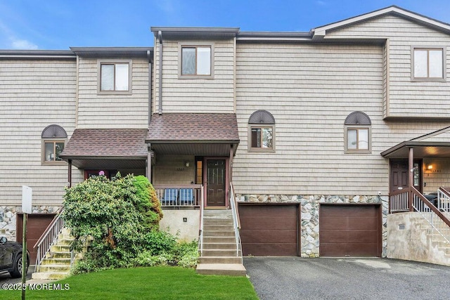 1202 Alpine Trl, Neptune Township, NJ 07753 - townhome / multi-family property featuring stairs, a garage, driveway, a porch, and stone siding