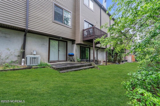 1202 Alpine Trl, Neptune Township, NJ 07753 - rear view of house featuring cooling unit, a lawn, stucco siding, and a balcony