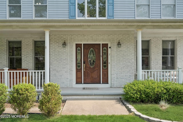 7 Cranberry Ct, Haledon, NJ 07508 - doorway to property with covered porch and brick siding