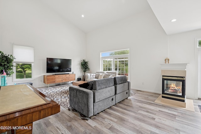 7 Cranberry Ct, Haledon, NJ 07508 - living area with high vaulted ceiling, light wood finished floors, a fireplace, and recessed lighting