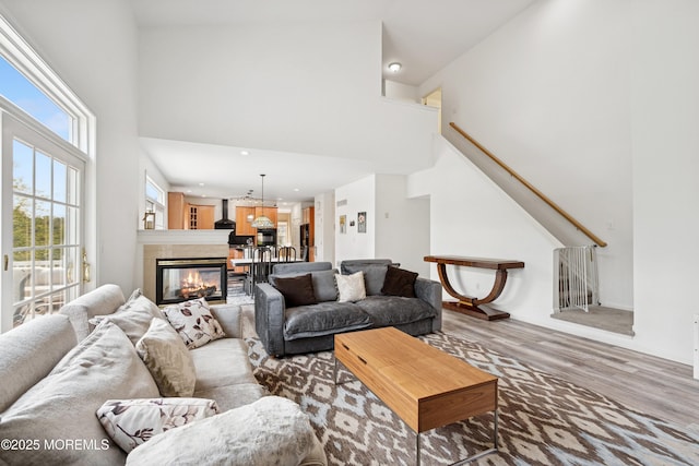 7 Cranberry Ct, Haledon, NJ 07508 - living area featuring a high ceiling, wood finished floors, a tiled fireplace, recessed lighting, and stairway