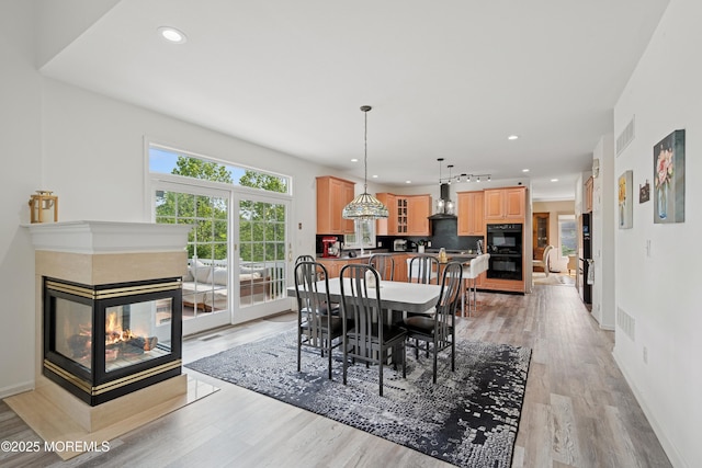 7 Cranberry Ct, Haledon, NJ 07508 - dining room with a multi sided fireplace, light wood-type flooring, and recessed lighting