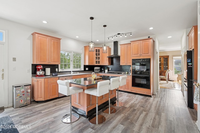 7 Cranberry Ct, Haledon, NJ 07508 - kitchen with black appliances, wall chimney range hood, light wood-style flooring, backsplash, and recessed lighting