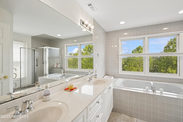 7 Cranberry Ct, Haledon, NJ 07508 - full bath featuring a garden tub, double vanity, plenty of natural light, a stall shower, and recessed lighting