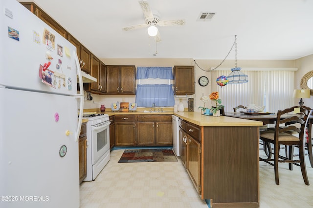 62 Virgin Islands Dr, Toms River, NJ 08757 - kitchen featuring white appliances, a sink, a peninsula, and light floors