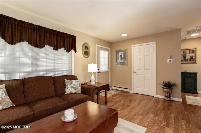 648 Pulham Ct Unit B, Manchester, NJ 08759 - living area featuring a baseboard heating unit, wood finished floors, and baseboards