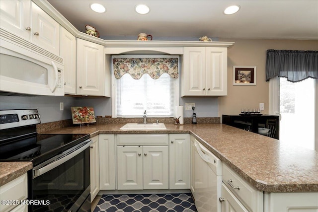 648 Pulham Ct Unit B, Manchester, NJ 08759 - kitchen with white appliances, a sink, white cabinetry, a peninsula, and recessed lighting