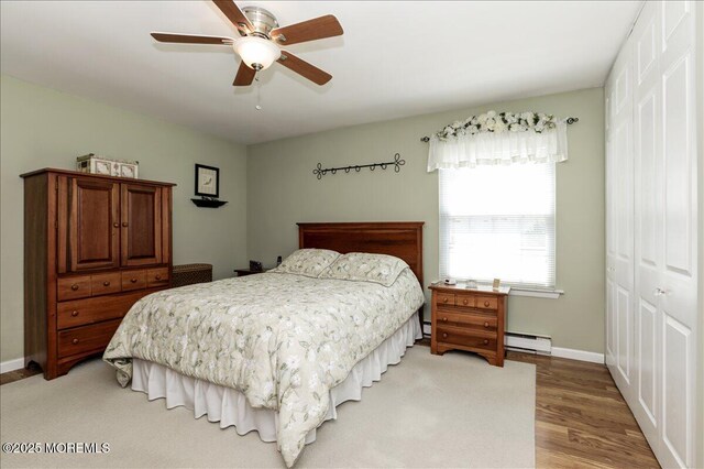 648 Pulham Ct Unit B, Manchester, NJ 08759 - bedroom featuring a baseboard heating unit, a closet, light wood finished floors, and baseboards