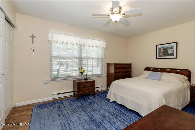 648 Pulham Ct Unit B, Manchester, NJ 08759 - bedroom featuring wood finished floors, baseboard heating, baseboards, a baseboard radiator, and a closet