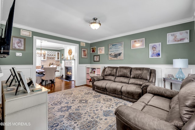 913 Lorillard Ave, Union Beach, NJ 07735 - living room featuring crown molding, a wainscoted wall, a chandelier, and wood finished floors