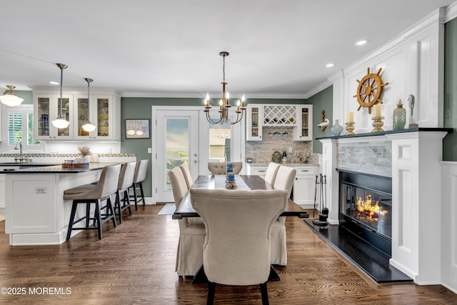 913 Lorillard Ave, Union Beach, NJ 07735 - dining space featuring a chandelier, recessed lighting, ornamental molding, a fireplace, and dark wood finished floors