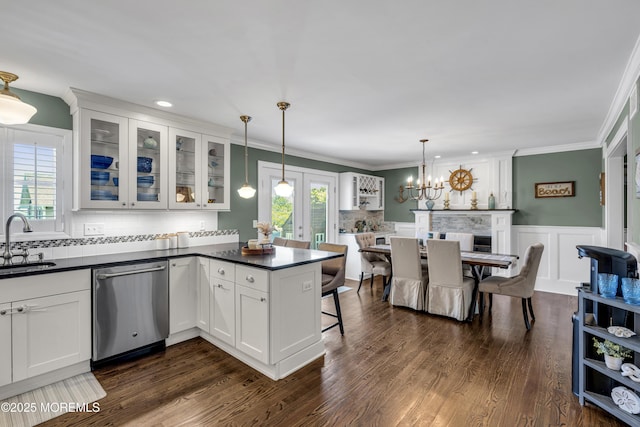 913 Lorillard Ave, Union Beach, NJ 07735 - kitchen with stainless steel dishwasher, a sink, dark countertops, tasteful backsplash, and white cabinetry