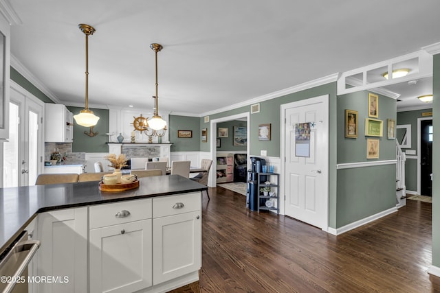 913 Lorillard Ave, Union Beach, NJ 07735 - kitchen featuring crown molding, white cabinets, dark wood-style floors, dark countertops, and wainscoting