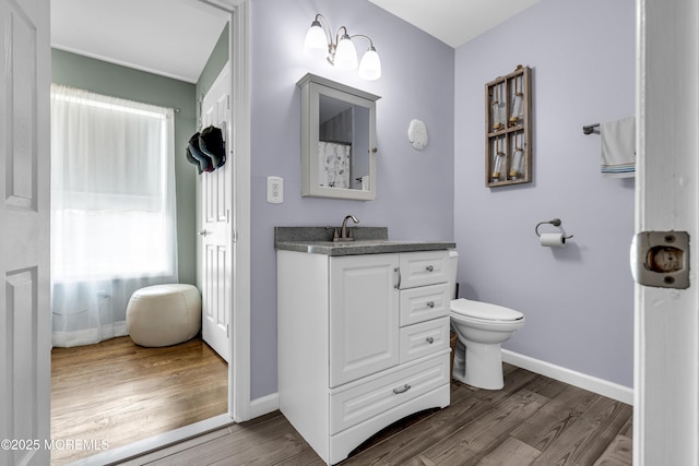 913 Lorillard Ave, Union Beach, NJ 07735 - full bath featuring vanity, toilet, wood finished floors, and baseboards