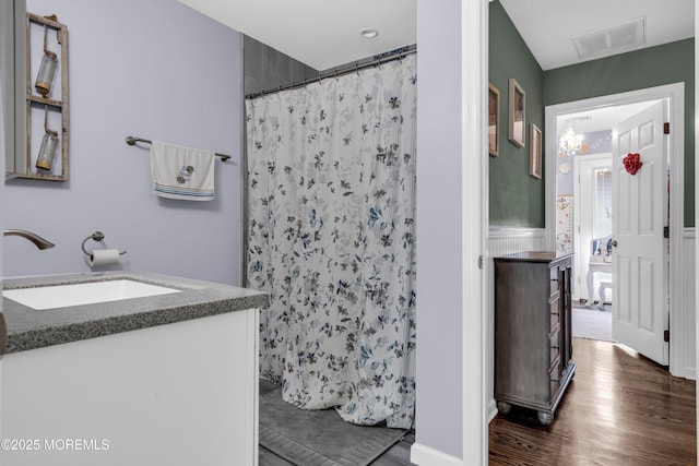 913 Lorillard Ave, Union Beach, NJ 07735 - full bath featuring vanity, wood finished floors, curtained shower, and a wainscoted wall