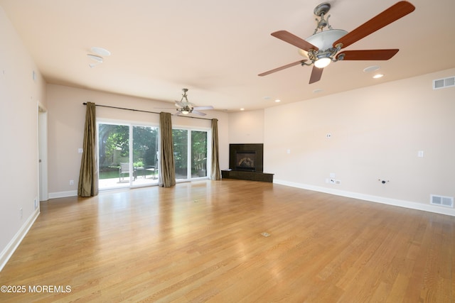 324 Magnolia Ave, Brielle, NJ 08730 - unfurnished living room with a ceiling fan, light wood-type flooring, a glass covered fireplace, and recessed lighting
