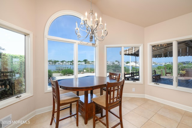 324 Magnolia Ave, Brielle, NJ 08730 - dining room with a chandelier, light tile patterned floors, a water view, and healthy amount of natural light