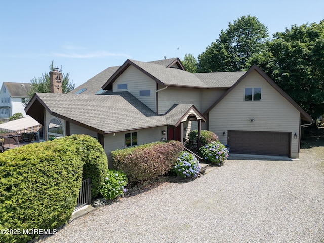 324 Magnolia Ave, Brielle, NJ 08730 - view of front of property with roof with shingles, a garage, driveway, and a chimney