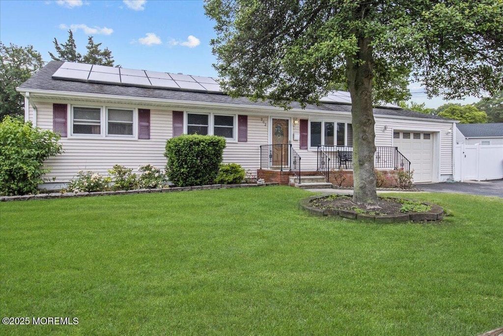 202 Nottingham Dr, Brick, NJ 08724 - ranch-style home featuring an attached garage, driveway, solar panels, and a front lawn
