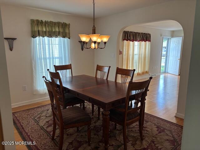 184 Pebble Beach Dr, Mays Landing, NJ 08330 - dining room with arched walkways, a chandelier, and light wood finished floors