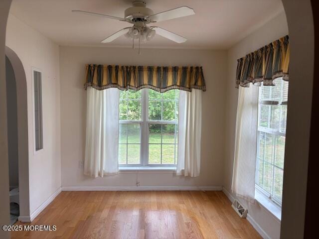 184 Pebble Beach Dr, Mays Landing, NJ 08330 - spare room featuring arched walkways, healthy amount of natural light, and light wood-type flooring