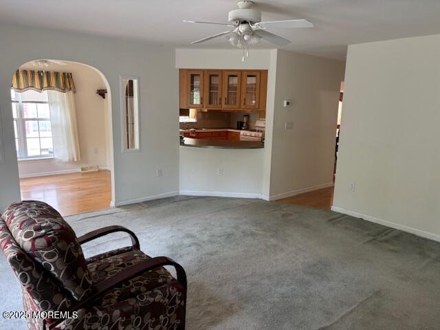 184 Pebble Beach Dr, Mays Landing, NJ 08330 - living area featuring ceiling fan, arched walkways, and light carpet