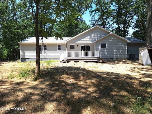 414 Oak Tree Rd, Freehold, NJ 07728 - rear view of house featuring a deck, crawl space, and a shed