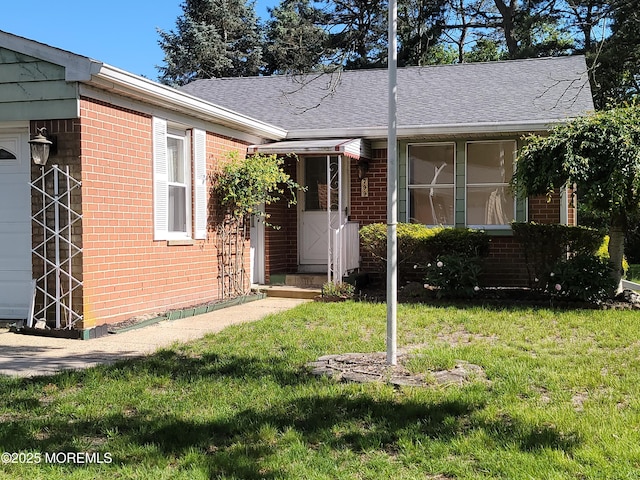 799 Hudson Pkwy, Whiting, NJ 08759 - view of exterior entry featuring brick siding, a lawn, and roof with shingles