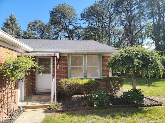 799 Hudson Pkwy, Whiting, NJ 08759 - property entrance featuring brick siding, a shingled roof, and a yard